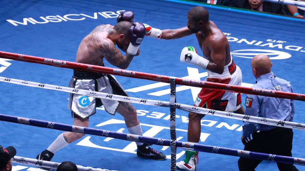 Floyd Mayweather Jr. (R) and John Gotti III exchange punches during their exhibition fight.